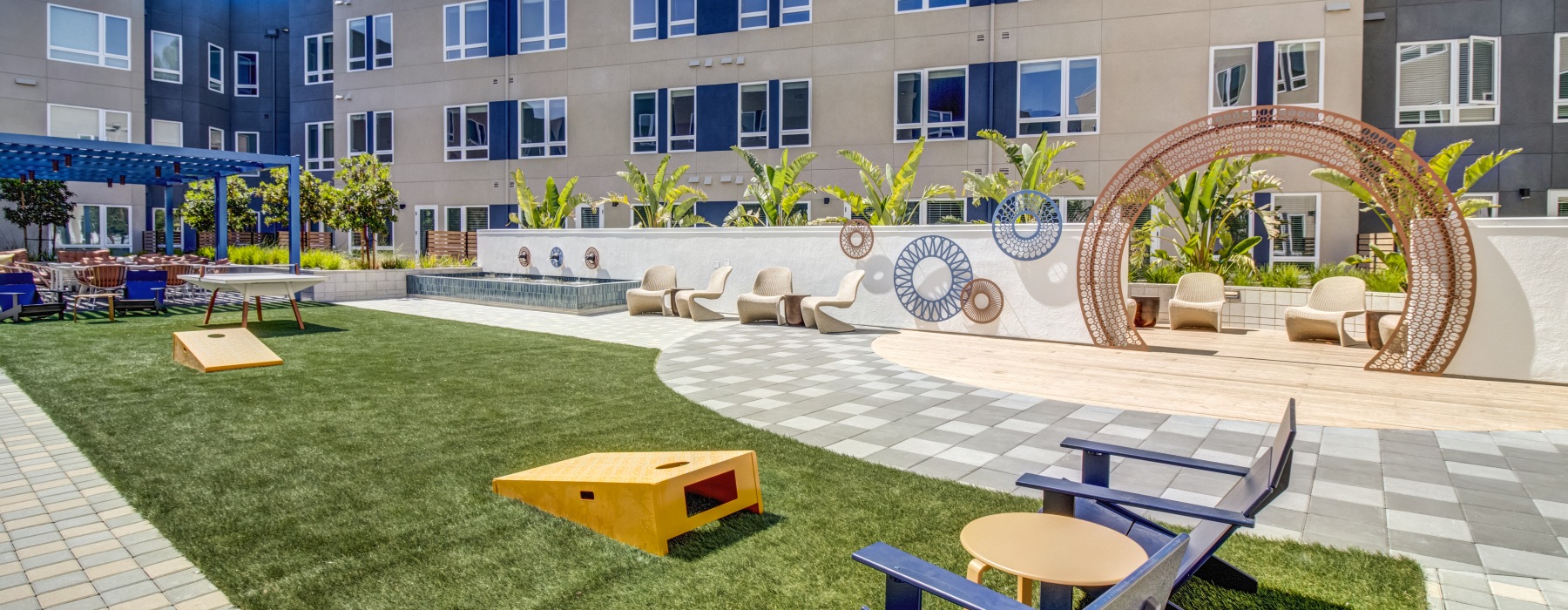 a courtyard with tables and chairs and buildings