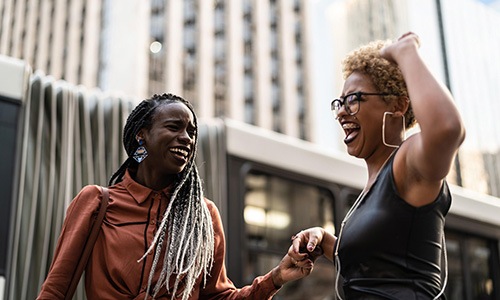 women laughing together in the city